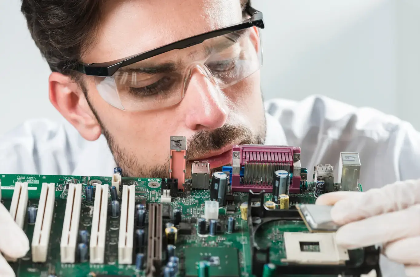 Homem olhando para uma placa de computador para ilustrar texto sobre engenharia da computação ead